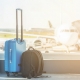 Hand luggage at the airport in front of an airplane