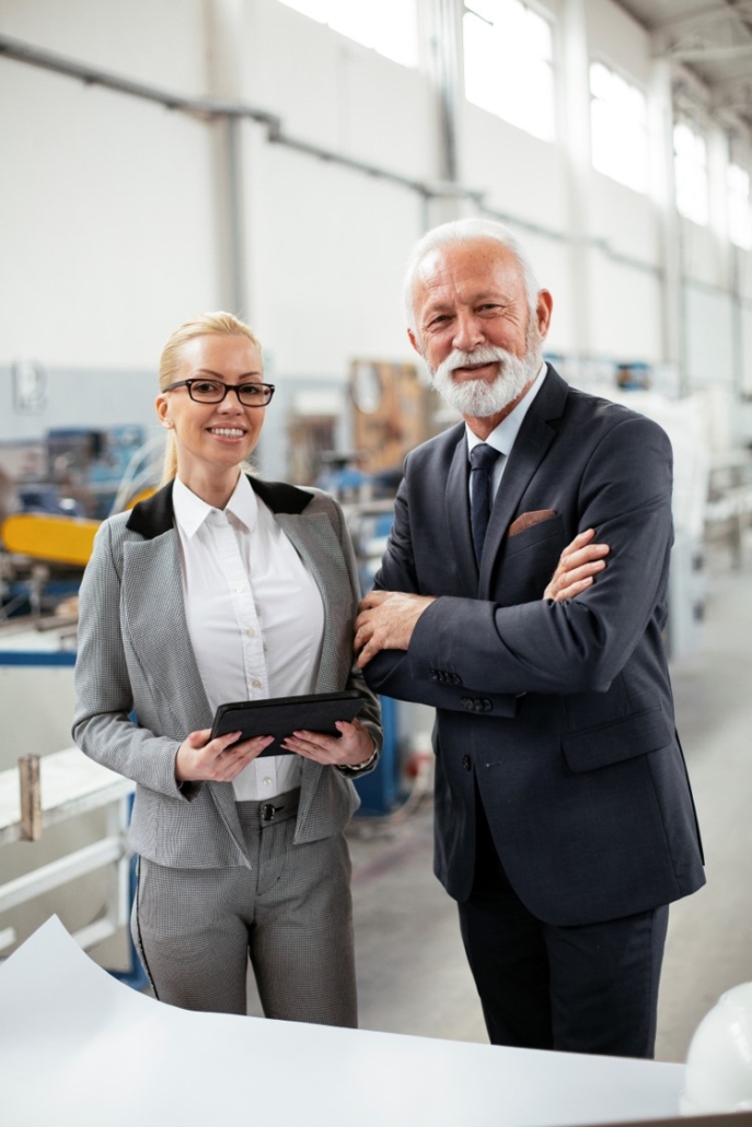 picture of two people smiling while the woman on the left holding a document related to business formation planning