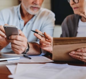 Couple with a calculator working out the details of their charitable trust