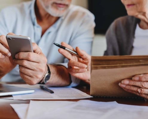 Couple with a calculator working out the details of their charitable trust