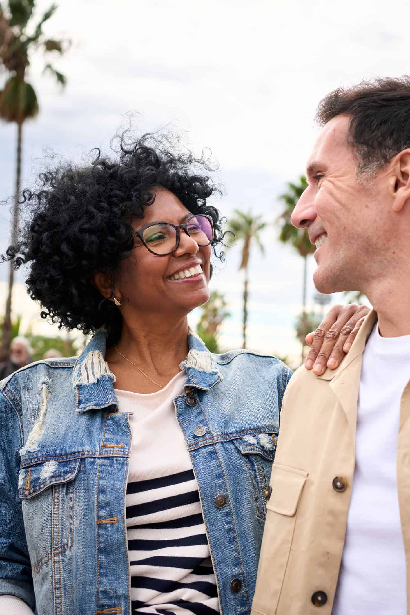Middle aged couple smiling at each other Middle aged couple smiling at each other